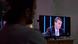 A man watching a TV with Jair Bolsonaro on the Journal Nacional news program A man watching a TV with Jair Bolsonaro on the Journal Nacional news program
