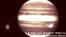 Fans of Jupiter will recognize some familiar features of our solar systemâs enormous planet in these images seen through Webbâs infrared gaze. A view from the NIRCam instrumentâs short-wavelength filter shows distinct bands that encircle the planet as well as the Great Red Spot, a storm big enough to swallow the Earth. The iconic spot appears white in this image because of the way Webbâs infrared image was processed. âCombined with the deep field images released [earlier], these images of Jupiter demonstrate the full grasp of what Webb can observe, from the faintest, most distant observable galaxies to planets in our own cosmic backyard that you can see with the naked eye from your actual backyard,â said Bryan Holler, a scientist at the Space Telescope Science Institute in Baltimore, who helped plan these observations. On the left, Jupiter glows in yellow with darker orange bands across it. Clearly visible at left is Europa, a moon with a probable ocean below its thick icy crust, and the target of NASAâs forthcoming Europa Clipper mission. Whatâs more, Europaâs shadow can be seen to the left of the Great Red Spot. Other visible moons in these images include Thebe and Metis. Credits: NASA, ESA, CSA, and B. Holler and J. Stansberry (STScI) via CNP