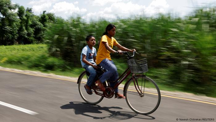 Parwati Sunar and her son ride their bike to computer class