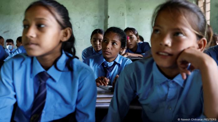 Parwati Sunar sits among students in class, listening attentively