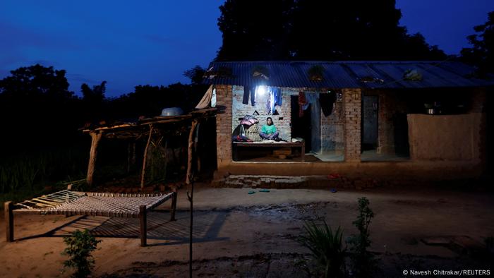 Sunar sits on the porch of her small brick house in Punarbas in the evening.