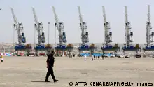 A police officer walks around during an inauguration ceremony of new equipment and infrastructure at Shahid Beheshti Port in the southeastern Iranian coastal city of Chabahar, on the Gulf of Oman, on February 25, 2019. (Photo by ATTA KENARE / AFP) (Photo credit should read ATTA KENARE/AFP via Getty Images)