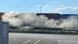 Several emergency workers try to contain a gas cloud at a shipping terminal Several emergency workers try to contain a gas cloud at a shipping terminal