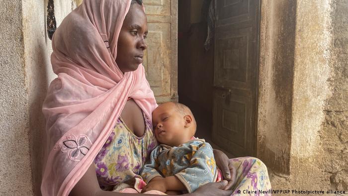 Hiwot and her baby Girmay, who is malnourished and receiving support from the World Food Programme (WFP), rest at their home in the Naeder district of the Tigray region of Ethiopia in May