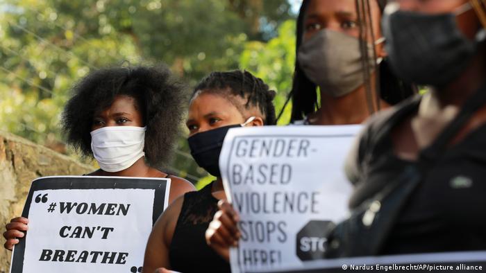 Activists, wearing masks to slow the spread of the coronavirus, picket outside the police headquarters in Cape Town, South Africa