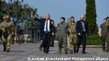 Ukrainian President Volodymyr Zelenskyy, center right, and Britain's Prime Minister Boris Johnson walk during their meeting in Kyiv, Ukraine, Wednesday, Aug. 24, 2022. British prime minister Boris Johnson urged western allies to maintain their strong support to Ukraine through the winter arguing that their position would improve after the cold weather ends. (AP Photo/Andrew Kravchenko)