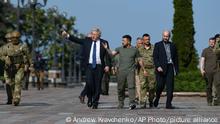 Ukrainian President Volodymyr Zelenskyy, center right, and Britain's Prime Minister Boris Johnson walk during their meeting in Kyiv, Ukraine, Wednesday, Aug. 24, 2022. British prime minister Boris Johnson urged western allies to maintain their strong support to Ukraine through the winter arguing that their position would improve after the cold weather ends. (AP Photo/Andrew Kravchenko)