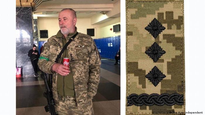 Screenshot The Kyiv Independent |  Man in camouflage holding a soft drink, closeup of epaulette 