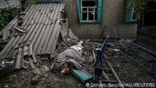 The covered body of an 11-year-old child, who was killed by a Russian military strike, lies on the ground, as Russia's attack on Ukraine continues, in Chaplyne, Dnipropetrovsk region, Ukraine August 24, 2022. REUTERS/Dmytro Smolienko