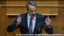 Greece's Prime Minister Kyriakos Mitsotakis speaks during a parliament session in Athens, Greece, Friday, Aug. 26, 2022. Greek lawmakers are discussing a wiretapping scandal that has roiled the government ahead of elections due to be held next year, in a parliamentary session called following revelations that the intelligence service had bugged an opposition politician's phone. (AP Photo/Thanassis Stavrakis)
