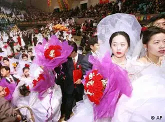 Newly wed couples leave a stadium after a mass wedding in Beijing Friday, Dec. 31, 1999. Some 2000 couples participated in the wedding on the last day of the millennium. (AP Photo/Chien-min Chung)