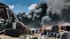People are seen in front of clouds of black smoke from fires in the aftermath at the scene of an airstrike in Mekele, the capital of the Tigray region of northern Ethiopia on Oct. 20, 2021. People are seen in front of clouds of black smoke from fires in the aftermath at the scene of an airstrike in Mekele, the capital of the Tigray region of northern Ethiopia on Oct. 20, 2021.