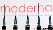 FILE PHOTO: Syringes with needles are seen in front of a displayed Moderna logo in this illustration taken November 27, 2021. REUTERS/Dado Ruvic/Illustration//File Photo