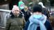 In this photo from January 2022, people are seen wearing face masks while walking outdoors in Krakow, Poland In this photo from January 2022, people are seen wearing face masks while walking outdoors in Krakow, Poland