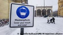 January 6, 2021, Munich, Bavaria, Germany: A mask requirement sign in front of the Feldherrnhalle in Munich, Germany during the first notable snowstorm of 2021 and the first real snowstorm of the winter 2020/2021 season.ÃÂ  The area saw only a previous dusting of snow.ÃÂ  The snow also coincides with Epiphany (ger: heilige drei Koenige, the three holy Kings) (Credit Image: © Sachelle Babbar/ZUMA Wire