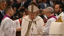 Pope Francis is helped getting dressed at the start of a consistory to create 20 new cardinals, on August 27, 2022 at St. Peter's Basilica in The Vatican. (Photo by Alberto PIZZOLI / AFP) (Photo by ALBERTO PIZZOLI/AFP via Getty Images)