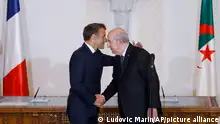 French President Emmanuel Macron, left, and Algerian President Abdelmadjid Tebboune shake hands during a signing ceremony at Algiers airport, in Algiers, Saturday, Aug. 27, 2022 . The leaders of France and Algeria took an important step Saturday toward mending relations scarred by disputes over migration and the legacy of colonial crimes. They agreed to cooperate on energy, security, medical research and reassessing their joint history. (Ludovic Marin, Pool via AP)