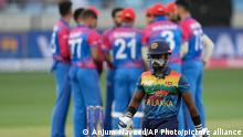 Sri Lanka's Charith Asalanka reacts while he walks back to pavilion after his dismissal during the T20 cricket match of Asia Cup between Afghanistan and Sri Lanka, in Dubai, United Arab Emirates, Saturday, Aug. 27, 2022. (AP Photo/Anjum Naveed)