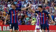 Barcelona's Pedri, second right, celebrates with Robert Lewandowski after scoring his side's second goal during a Spanish La Liga soccer match between FC Barcelona and Valladolid CF at the Camp Nou stadium in Barcelona, Spain, Sunday, Aug. 28, 2022. (AP Photo/Joan Monfort)