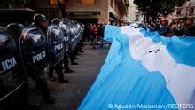 Supporters gather outside the house of Argentina's Vice President Cristina Fernandez de Kirchner as police officers hold their shields, days after Fernandez was accused in a corruption case, in Buenos Aires, Argentina, August 27, 2022. REUTERS/Agustin Marcarian TPX IMAGES OF THE DAY 