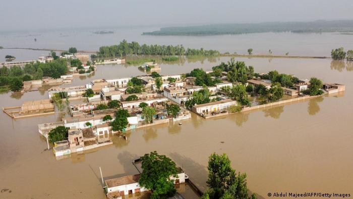 Brown water covers the city of Charsadda, with just trees and parts of houses still visible from the air