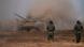 Russian battle tank and serviceman during Caucasus-2020 drills; a plume of dust is seen behind the tank Russian battle tank and serviceman during Caucasus-2020 drills; a plume of dust is seen behind the tank