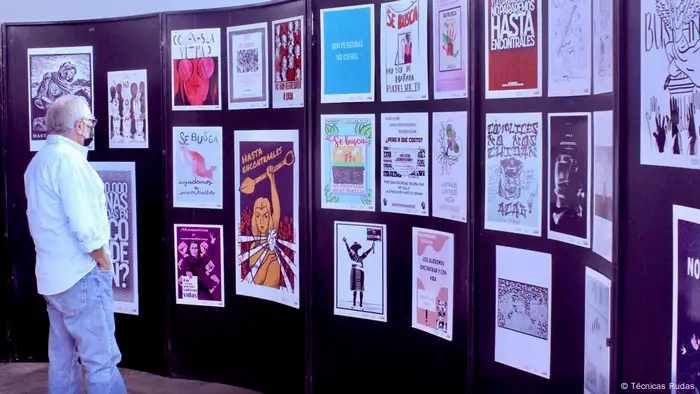 A member of the public looks on at a poster exhibition.