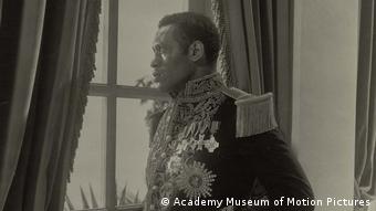 Paul Robeson in his medal-decorated jacket in The Emperor Jones (1933) looks out a window 