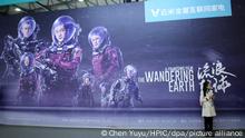 Visitors pose in front of a poster of Chinese sci-fi blockbuster The Wandering Earth during an expo in Shanghai, China, 15 March 2019. Over four years of devotion, 7,000 crew members and several investors willing to take the plunge ¡ª it took a lot for Chinese sci-fi blockbuster The Wandering Earth to become a surprise hit. The film, released during February's Lunar New Year holiday earned over 4.63 billion yuan ($689.74 million) as of March 19. That made it China's second-highest grossing film of all time, after 2017 action flick Wolf Warrior 2. The Wandering Earth is an adaptation of a novella by acclaimed Chinese sci-fi author Liu Cixin, winner of the prestigious Hugo Award for sci-fi fiction writing. Set in a distant future in which the sun is about to expand into red giant and devour the Earth, engineers from around the world scramble to devise a plan to move the planet into a new solar system using giant thrusters. Things take a turn for the worse when the Earth nears Jupiter, sparking a desperate mission to save humanity from extinction.