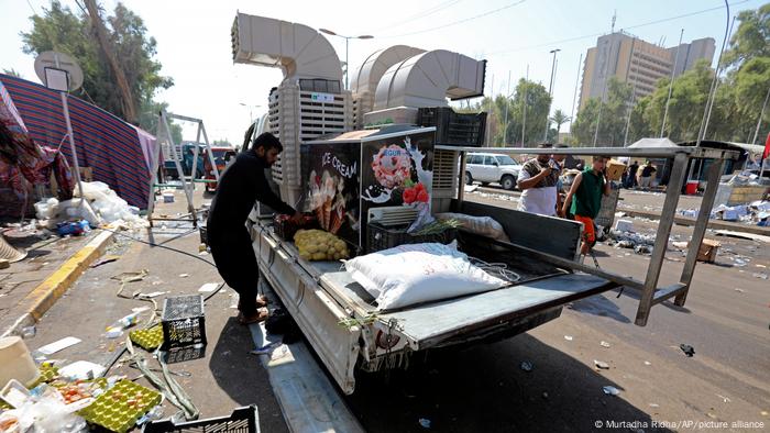 A supporter of Iraqi cleric Moqtada al-Sadr removes a food stand as the protesters withdraw from outside the parliament building inside Baghdad.