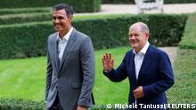 German Chancellor Olaf Scholz and Spanish Prime Minister Pedro Sanchez walk on the day of a closed German cabinet meeting at the government's guest house in Schloss Meseberg, near Gransee, Germany August 30, 2022. REUTERS/Michele Tantussi