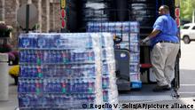 Pallets loaded with cases of water are unloaded at a Kroger grocery store in north Jackson, Miss., Tuesday, Aug. 30, 2022. The grocery chain and other stores are facing the challenges of the city's longstanding water system problems, by making more drinking water available for its customers. Recent flooding worsened problems in one of two water-treatment plants and the state Health Department has had Mississippi's capital city under a boil-water notice since late July. (AP Photo/Rogelio V. Solis)