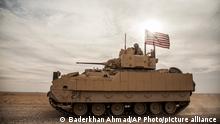 08.12.2021****American soldiers drive a Bradley fighting vehicle during a joint exercise with Syrian Democratic Forces at the countryside of Deir Ezzor in northeastern Syria, Wednesday, Dec. 8, 2021. .(AP Photo/Baderkhan Ahmad)