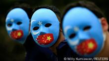 FILE PHOTO: Activists take part in a protest against China's treatment towards the ethnic Uyghur people and calling for a boycott of the 2022 Winter Olympics in Beijing, at a park Jakarta, Indonesia, January 4, 2022. REUTERS/Willy Kurniawan/File Photo