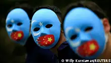 FILE PHOTO: Activists take part in a protest against China's treatment towards the ethnic Uyghur people and calling for a boycott of the 2022 Winter Olympics in Beijing, at a park Jakarta, Indonesia, January 4, 2022. REUTERS/Willy Kurniawan/File Photo