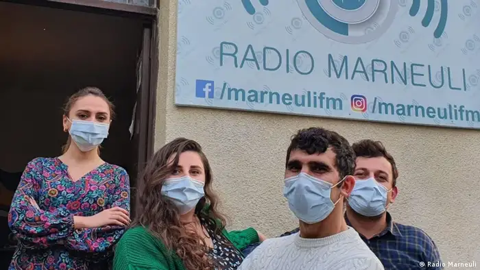 Four journalists stand outside their offices at Radio Marneuli