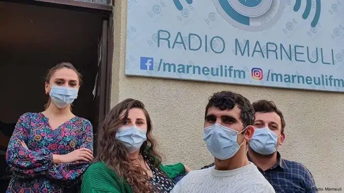 Four journalists stand outside their offices at Radio Marneuli