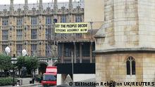 A protest banner dropped by Extinction Rebellion activists hangs outside the Palace of Westminster, the meeting place for the Houses of Parliament, in London, Britain September 2, 2022 in this picture obtained from social media. Extinction Rebellion UK/via REUTERS THIS IMAGE HAS BEEN SUPPLIED BY A THIRD PARTY. MANDATORY CREDIT. NO RESALES. NO ARCHIVES.