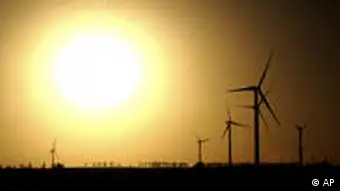 In this photo taken by on Nov. 26, 2010 and released by China's Xinhua News Agency, turbines of Dingbian Fanshigou wind power plant, Shaanxi's first of its kind, stand against the sunset in Yulin, northwest China's Shaanxi Province as the traditional mineral-resource-rich city turned its development on clean energy industries such as wind power or solar power, which become the city's new pillar industries, Xinhua said. Beijing promised new subsidies to develop China's solar power industry Thursday, Dec. 2, 2010, policies already under fire from the United States as a possible trade violation. (AP Photo/Xinhua, Liu Xiao) NO SALES