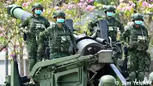 (FILES) In this file photo taken on April 09, 2020 female soldiers wearing face masks amid the COVID-19 coronavirus pandemic stand in formation on a US-made M110A2 self-propelled howitzer during Taiwan President Tsai Ing-wen's visit to a military base in Tainan, southern Taiwan. - The United States on September 2, 2022 announced a new $1.1 billion package of arms to Taiwan, vowing to keep boosting the island's defenses as tensions soar with Beijing. The sale comes a month after House Speaker Nancy Pelosi defiantly visited the self-governing democracy, prompting mainland China to launch a show of force that could be a trial run for a future invasion. (Photo by Sam Yeh / AFP) / TO GO WITH: Taiwan-China-politics-unrest, FOCUS by Catherine LAI, Jack MOORE