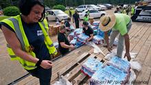 Jackson City firefighters and Humana volunteers help distribute over forty thousand bottles of water and three thousand MRE's to Jackson residents Friday Sep. 2, 2022, in Jackson, Miss. (AP Photo/Steve Helber)