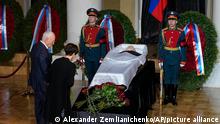 People stand by the coffin of former Soviet President Mikhail Gorbachev inside the Pillar Hall of the House of the Unions during a farewell ceremony in Moscow, Russia, Saturday, Sept. 3, 2022. Gorbachev, who died Tuesday at the age of 91, will be buried at Moscow's Novodevichy cemetery next to his wife, Raisa, following a farewell ceremony at the Pillar Hall of the House of the Unions, an iconic mansion near the Kremlin that has served as the venue for state funerals since Soviet times. (AP Photo/Alexander Zemlianichenko)