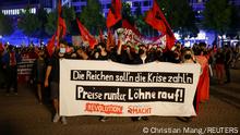 People take part in a left-wing protest against increasing energy prices and rising living expenses in Leipzig, Germany, September 5, 2022. The banner reads: Let the rich pay for the crisis. Prices down, wages up!. REUTERS/Christian Mang