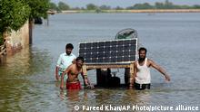 Victims of unprecedented flooding from monsoon rains use a cot to salvage belongings from their flooded home, in Jaffarabad, Pakistan, Monday, Sept. 5, 2022. The U.N. refugee agency rushed in more desperately needed aid Monday to flood-stricken Pakistan as the nation's prime minister traveled to the south where rising waters of Lake Manchar pose a new threat. (AP Photo/Fareed Khan)