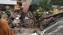 In this photo released by Xinhua News Agency, soldiers clear debris to search for survivors at an earthquake hit Moxi Town of Luding County, southwest China's Sichuan Province Tuesday, Sept. 6, 2022. Authorities in southwestern China's Chengdu have maintained strict COVID-19 lockdown measures on the city of 21 million despite a major earthquake that killed more than dozens people in outlying areas. (Ran Peizong/Xinhua via AP)