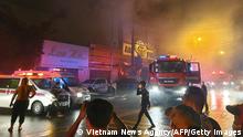 This picture taken on September 6, 2022 and released on September 7 by the Vietnam News Agency shows firefighters at the scene of a deadly fire that engulfed a karaoke bar in Binh Duong province, north of Ho Chi Minh City. - A fire tore through a karaoke bar in Vietnam killing 12 people and leaving 11 injured, a local official said September 7. (Photo by Vietnam News Agency / AFP) (Photo by STR/Vietnam News Agency/AFP via Getty Images)