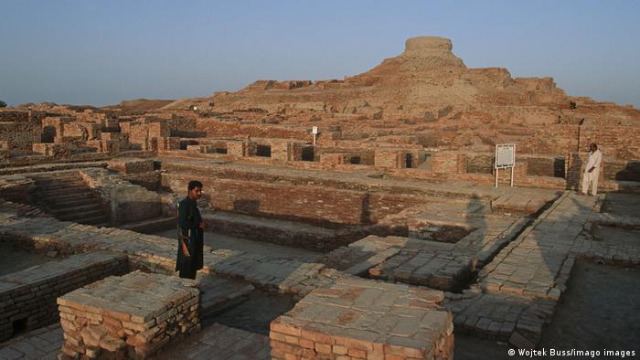 Mohenjo Daro, view of the brick ruins, a person stands in the foreground