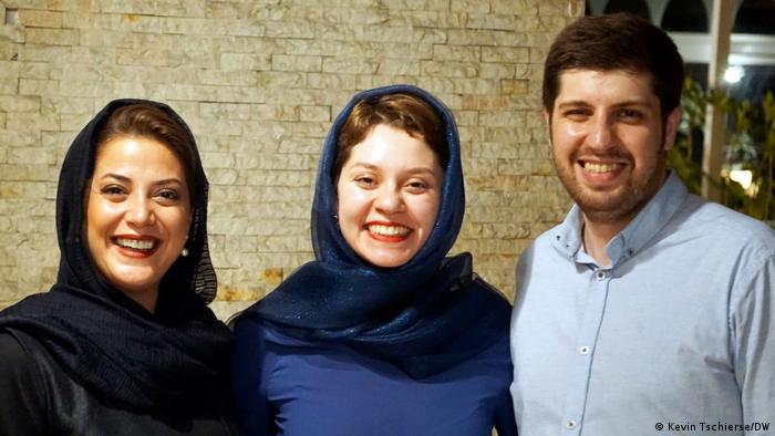 Filmmaker Arian Vazirdaftaris (right with blue shirt; smiling) with the actresses from his film Bi Roya: Shadi Karamroudi (middle; smiling with headscarf) and Tannaz Tabatabaei (left; smiling with headscarf)
