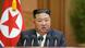 North Korean leader Kim Jong Un behind five microphones and in front of North Korean flag in Supreme People's Assembly North Korean leader Kim Jong Un behind five microphones and in front of North Korean flag in Supreme People's Assembly