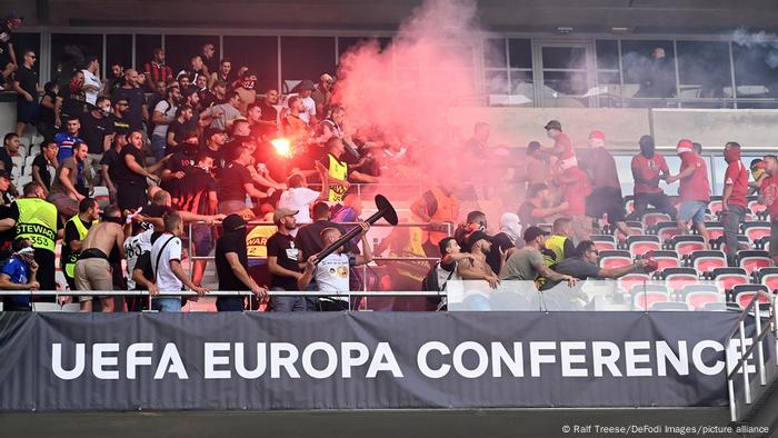 Nice hooligans (left) responded by throwing flares and other objects